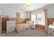 Bright bedroom with two-tone walls, floral bedding, and ample natural light at 6586 W Winding Bnd, McCordsville, IN 46055
