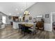 Bright dining area featuring an elegant light fixture, a dining table, and hardwood floors at 6586 W Winding Bnd, McCordsville, IN 46055