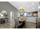 Dining area showcasing a wooden table and chairs beneath decorative lighting and hardwood floors at 6586 W Winding Bnd, McCordsville, IN 46055