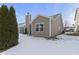 Rear exterior view with neutral siding, updated windows and snowy yard at 6586 W Winding Bnd, McCordsville, IN 46055