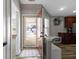 Bright foyer with a view into the kitchen and a glimpse of the front yard at 6586 W Winding Bnd, McCordsville, IN 46055