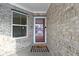 Close-up of the front door, brick facade, and an 'Oh Hello' welcome mat at 6586 W Winding Bnd, McCordsville, IN 46055