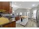Well-lit kitchen featuring wood cabinets, granite countertops, and a convenient kitchen island at 6586 W Winding Bnd, McCordsville, IN 46055