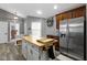 Butcher block island, stainless fridge, decor and dark cabinetry create an inviting kitchen at 6586 W Winding Bnd, McCordsville, IN 46055