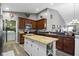 Kitchen with island, wooden cabinets, stainless steel appliances, and laundry access at 6586 W Winding Bnd, McCordsville, IN 46055