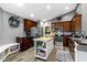 Well-lit kitchen featuring wood cabinets, stainless steel appliances, and a functional island at 6586 W Winding Bnd, McCordsville, IN 46055