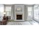 Cozy living room centered around a fireplace with large windows and neutral decor at 6586 W Winding Bnd, McCordsville, IN 46055