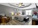 Tranquil main bedroom featuring a cozy seating area, soft lighting, and a large bed at 6586 W Winding Bnd, McCordsville, IN 46055