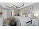 Serene main bedroom with a tray ceiling, comfortable bed, and elegant decor at 6586 W Winding Bnd, McCordsville, IN 46055