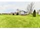 Extensive backyard featuring green grass, mature trees, and a charming wooden deck at 6591 Rushing, Noblesville, IN 46062