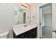 Neutrally decorated bathroom with vanity, medicine cabinet and a glimpse of the shower area at 6591 Rushing, Noblesville, IN 46062