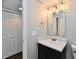 Bathroom featuring vanity with black cabinets, white countertop, sink, and a mirror at 6591 Rushing, Noblesville, IN 46062