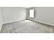 A bright bedroom features neutral walls, carpet flooring, and a window at 6591 Rushing, Noblesville, IN 46062