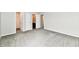 A bedroom featuring neutral walls, carpet flooring, and several doors at 6591 Rushing, Noblesville, IN 46062