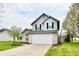 Charming two-story home with brick and siding, a well-maintained lawn, and an attached two-car garage at 6591 Rushing, Noblesville, IN 46062