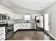 Beautiful kitchen features stainless steel appliances, granite countertops, and wood-look flooring at 6591 Rushing, Noblesville, IN 46062