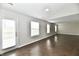 Spacious, light-filled living room with dark wood-look floors and natural light at 6591 Rushing, Noblesville, IN 46062