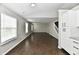 Bright living room area with dark laminate flooring and ample natural light at 6591 Rushing, Noblesville, IN 46062