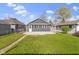 Charming home featuring a backyard with a small wooden deck, perfect for outdoor entertaining and relaxation at 67 S 9Th Ave, Beech Grove, IN 46107