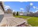 Backyard featuring a wood deck, green grass, a fire pit, and a detached garage at 67 S 9Th Ave, Beech Grove, IN 46107