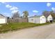 Backyard view highlighting the house's location, with a shed for storage and ample green space at 67 S 9Th Ave, Beech Grove, IN 46107
