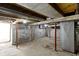 Unfinished basement showing exposed duct work, red support beams, and a concrete floor at 67 S 9Th Ave, Beech Grove, IN 46107