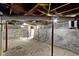 Unfinished basement showing exposed plumbing, red support beams, and a concrete floor at 67 S 9Th Ave, Beech Grove, IN 46107