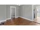 Dining room with hardwood floors, gray walls and storage shelves at 67 S 9Th Ave, Beech Grove, IN 46107
