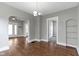 Open dining area features hardwood floors and fresh neutral paint at 67 S 9Th Ave, Beech Grove, IN 46107