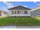 Charming home featuring a covered front porch and well-manicured lawn, creating a welcoming curb appeal at 67 S 9Th Ave, Beech Grove, IN 46107