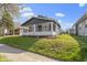 Classic home with a inviting front porch, complemented by lush greenery, offers a warm and attractive exterior at 67 S 9Th Ave, Beech Grove, IN 46107