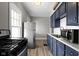 Fully equipped kitchen featuring a gas range, and stainless steel refrigerator at 67 S 9Th Ave, Beech Grove, IN 46107