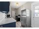 Efficient kitchen features stainless steel fridge, oven and ample counter space at 67 S 9Th Ave, Beech Grove, IN 46107