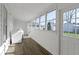 Bright laundry room featuring wood floors, a large window, and a white washer and dryer at 67 S 9Th Ave, Beech Grove, IN 46107