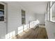 A bright, white laundry room featuring wood floors, a washer and dryer, and a window at 67 S 9Th Ave, Beech Grove, IN 46107