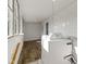Bright laundry room with wood floors featuring a washer and dryer, and large window at 67 S 9Th Ave, Beech Grove, IN 46107