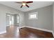 Open living room with polished wood floors, bright windows, and an open entrance is perfect for modern living at 67 S 9Th Ave, Beech Grove, IN 46107