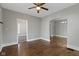 Spacious living room featuring hardwood floors, ceiling fan and neutral paint at 67 S 9Th Ave, Beech Grove, IN 46107
