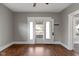 Bright living room with hardwood floors and neutral paint, enhanced by a glass door leading to the outside at 67 S 9Th Ave, Beech Grove, IN 46107