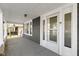 Spacious front porch, framed by white columns, offers an inviting entrance and a cozy outdoor space at 67 S 9Th Ave, Beech Grove, IN 46107
