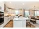 Spacious kitchen with white cabinetry, stainless steel appliances, and an island with seating at 7076 Portico Ln, McCordsville, IN 46055