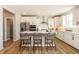 Modern kitchen with white cabinets, stainless steel appliances, and a quartz countertop island at 7076 Portico Ln, McCordsville, IN 46055