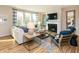 Comfortable living room featuring a fireplace, stylish seating, and natural light from expansive windows at 7076 Portico Ln, McCordsville, IN 46055