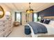 Elegantly decorated main bedroom with an accent wall, statement lighting, and a calming color scheme at 7076 Portico Ln, McCordsville, IN 46055