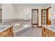 This bath features a tiled soaking tub, tile floor, and a double sink vanity at 7113 Lakeside Woods Dr, Indianapolis, IN 46278