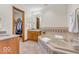 The primary bathroom boasts a soaking tub, tile floor, and a walk in closet at 7113 Lakeside Woods Dr, Indianapolis, IN 46278