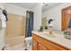 Well-lit bathroom featuring a tub with shower, toilet, and vanity with a single sink at 7113 Lakeside Woods Dr, Indianapolis, IN 46278