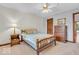 Bedroom featuring carpet, a ceiling fan, and a wooden dresser with a nightstand at 7113 Lakeside Woods Dr, Indianapolis, IN 46278