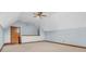 Unfurnished bonus room featuring carpet, a ceiling fan, and fresh, light blue paint at 7113 Lakeside Woods Dr, Indianapolis, IN 46278