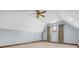 Spacious bonus room with carpet, a ceiling fan, and a charming arched window with curtains at 7113 Lakeside Woods Dr, Indianapolis, IN 46278